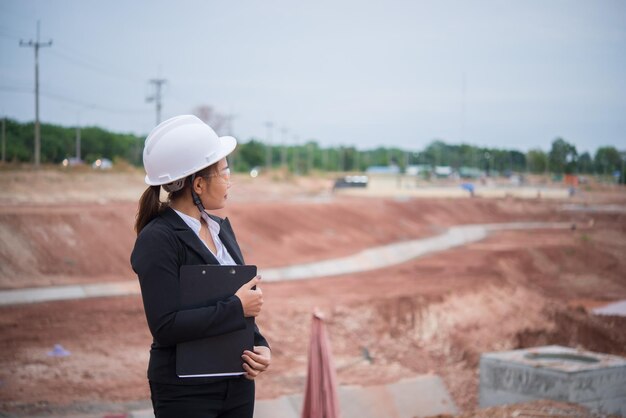 Engineer woman working at site of bridge under construction