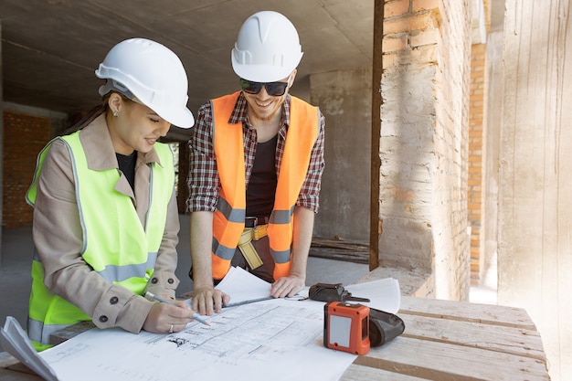 The engineer and worker control and check and coordinate the construction process