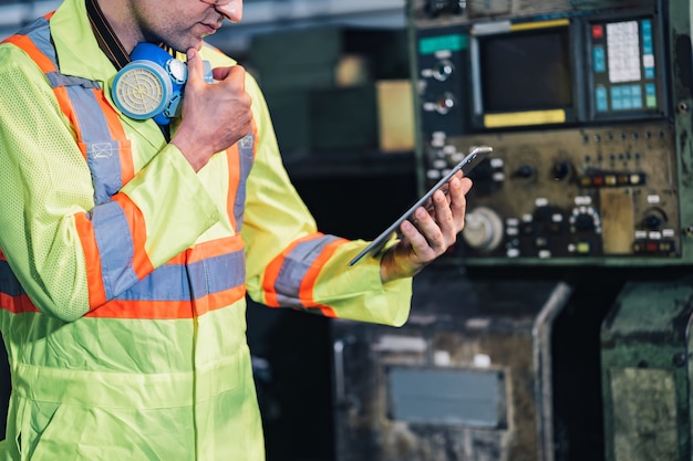 Engineer / worker man caucasian in protective safety jumpsuit uniform with yellow hardhat