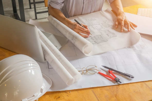 Engineer working on blueprint.Construction concept. Engineering tools.Vintage tone retro filter effect,soft focus(selective focus)