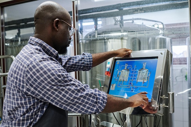 Engineer working on computer to control equipment