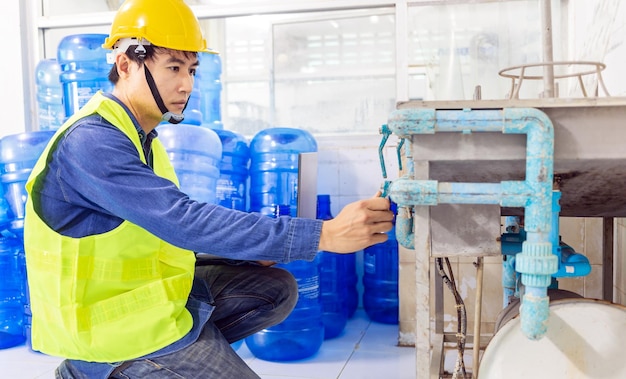 Engineer working in drink water factory to check and repair\
boiler water to the water system