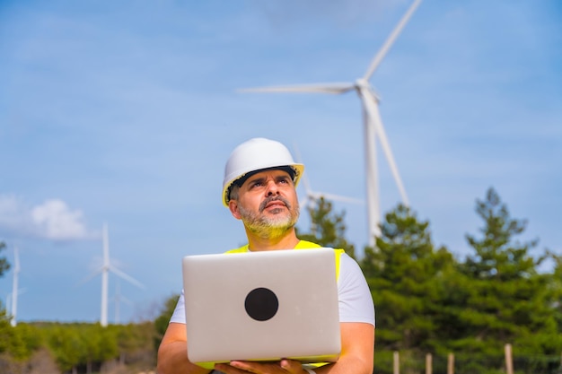 Engineer working in an ecological park producing wind energy