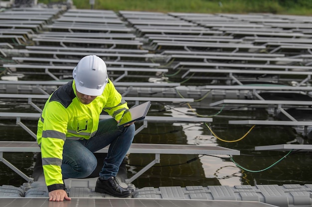 Engineer working at floating solar farmchecking and maintenance with solar batteries near solar panelssupervisor Check the system at the solar power station