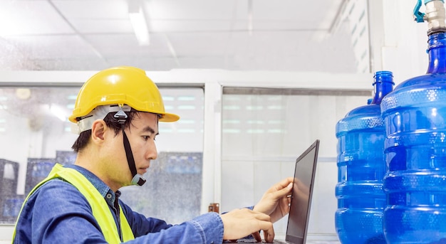 Engineer working using a tablet computer to check and repair boiler water to the water system
