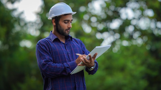 Engineer writing something on the diary