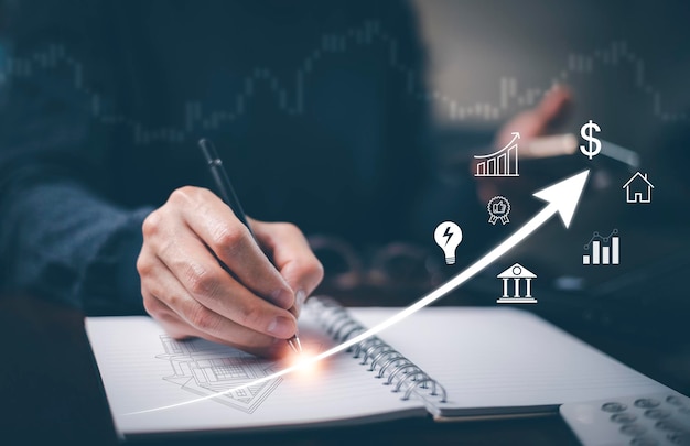 Engineering and architecture drawings concept Engineer using pen write projectof architect starting draw a house blueprint on the desk in the home office Corporate business technology