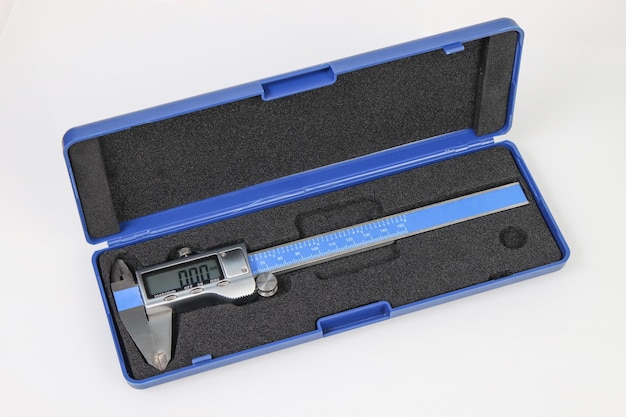 Engineering digital caliper in box on white background