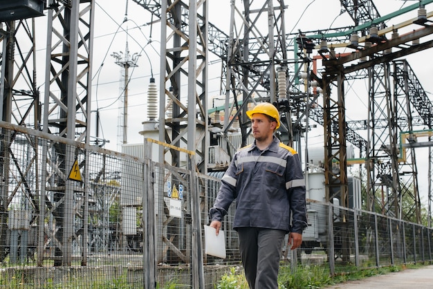 An engineering employee makes a tour and inspection of a modern electrical substation. Energy. Industry. 