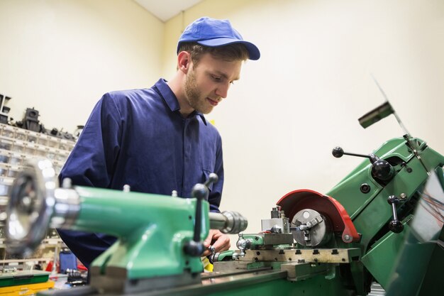 Engineering student using heavy machinery