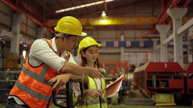 Engineering team meeting with technician and worker operating.
teamwork of industrial factory and manufacturing concept.