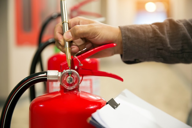 Engineers are checking fire extinguishers.