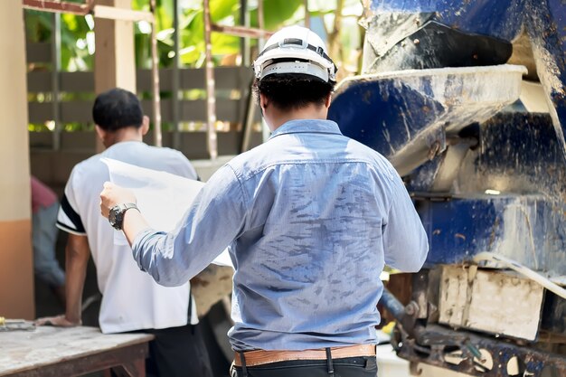 Engineers are controlling the cement pouring to building