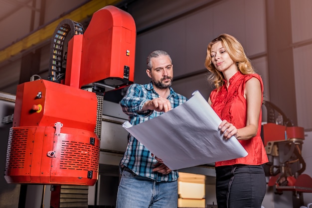 Ingegneri che controllano l'installazione della nuova macchina per plasma cnc