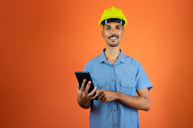 Engineers day Black Man in Safety Helmet and Blue Shirt isolated Engineer Holding Mobile