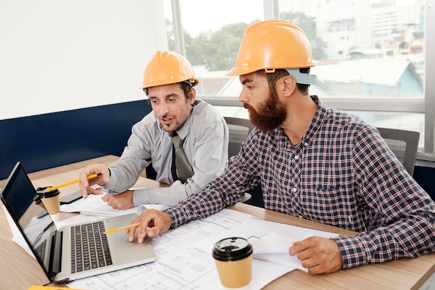 Engineers discussing project in laptop screen