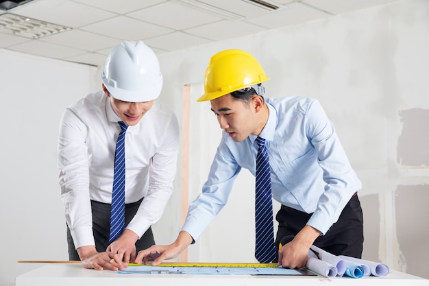 Engineers in helmets standing by the factory