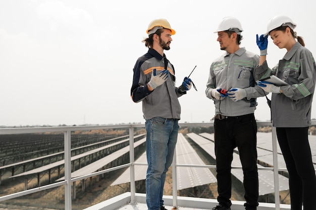 Engineers inspecting construction of solar panel at roof top solar farm with an energy storage system operated by Super Energy Corporation Workers Gathered testing Photovoltaic cells module