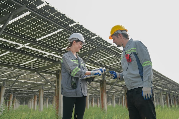 Engineers Meeting to check solar panel at roof top solar farm with an energy storage system operated by Super Energy Corporation Specialists Gathered for Outdoor testing Photovoltaic cells module