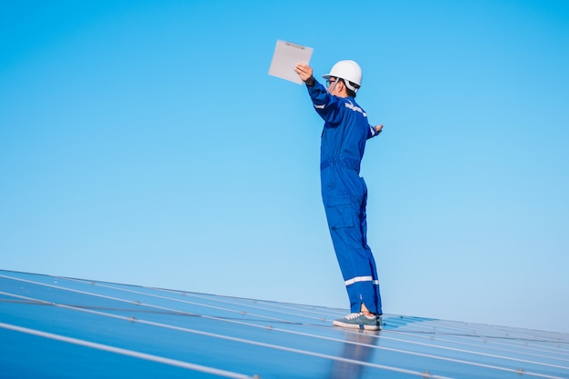 Engineers operating and check generating power of solar power plant on solar rooftop