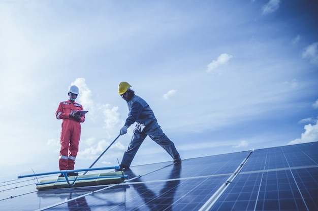 Engineers operating and check generating power of solar power plant on solar rooftop