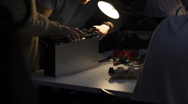 Engineers repairing a broken old computer