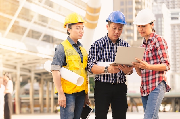 Engineers technology man and woman working on notebook plan building construction in city