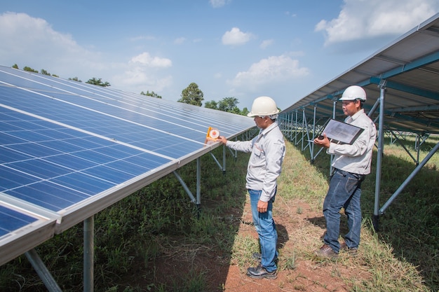 Engineers working on monitoring and maintenance of equipment at green power plants