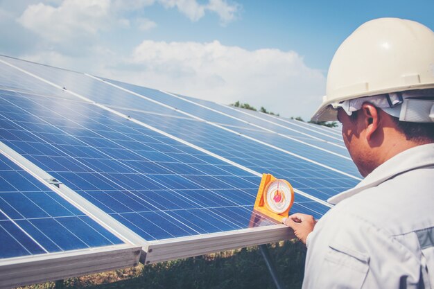 Engineers working on monitoring and maintenance of equipment at green power plants