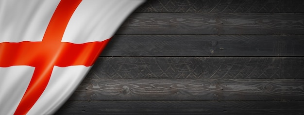 England flag on black wood wall. Horizontal panoramic banner.