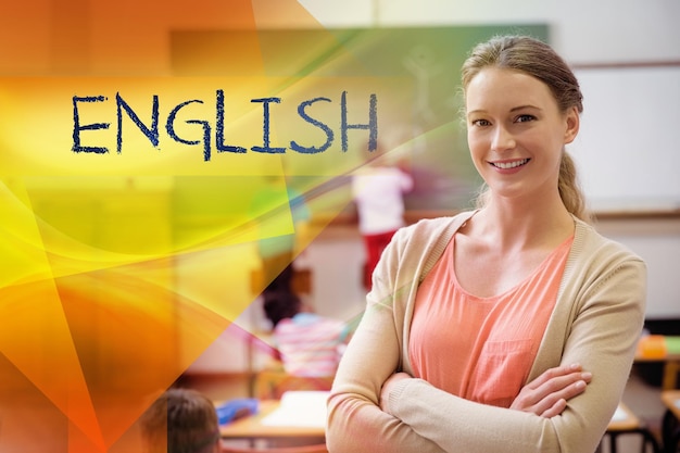 English against pretty teacher smiling at camera at back of classroom