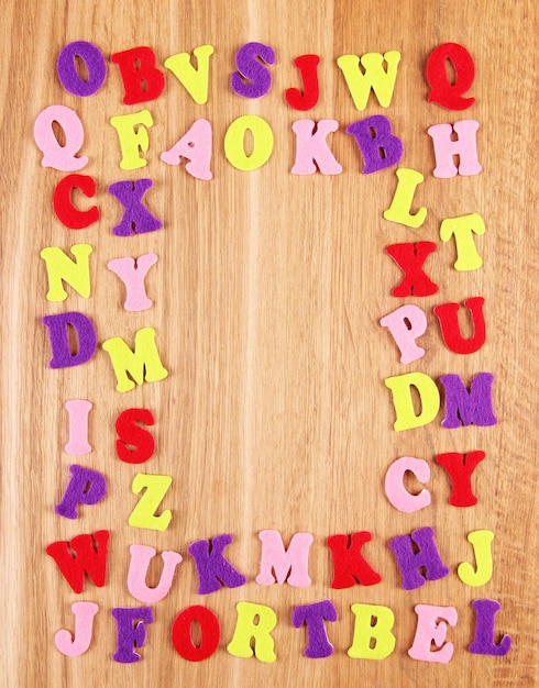 English alphabet on wooden background