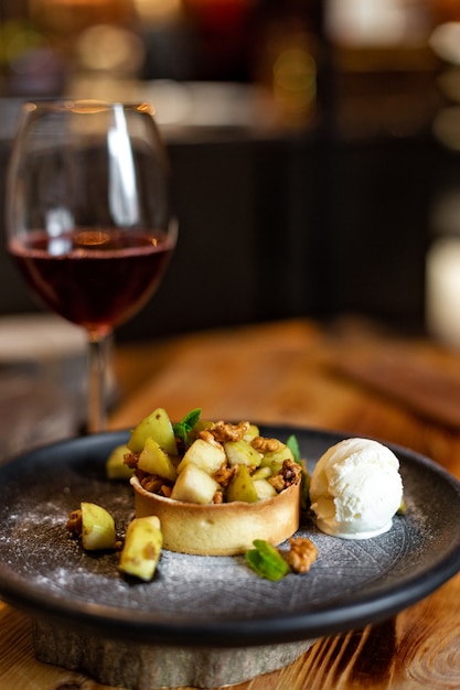 English apple crumble with nuts, mint and ice cream ball