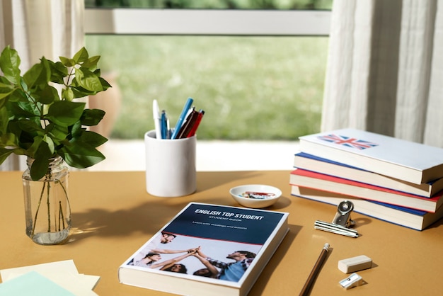 english books resting on the table of working space