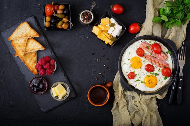 English breakfast - fried egg,  tomatoes and sausage. Top view. Flat lay