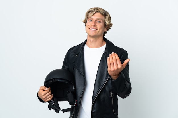 English man holding a motorcycle helmet inviting to come with hand. Happy that you came