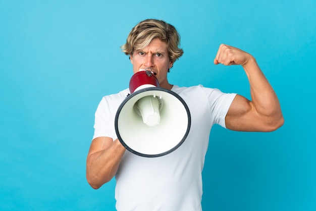 English man on isolated blue shouting through a megaphone to announce something