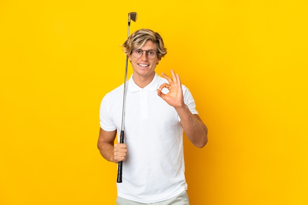 English man over isolated white playing golf making ok sign