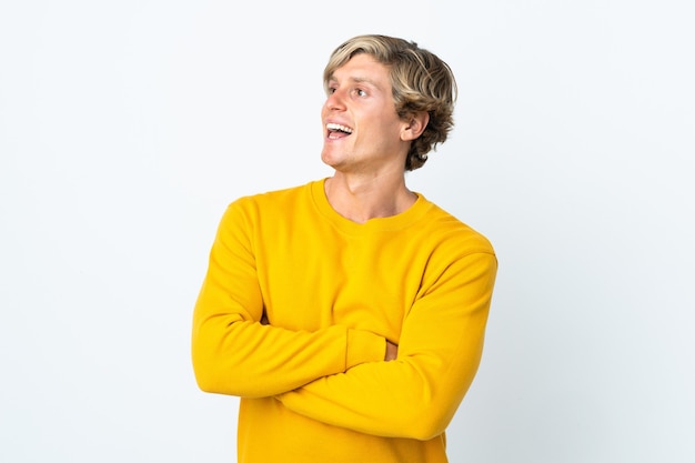 English man over isolated white wall happy and smiling