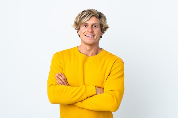 English man over isolated white wall keeping the arms crossed in frontal position