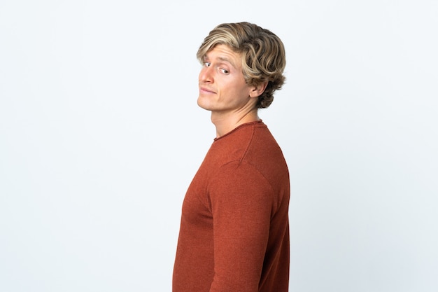 English man over isolated white wall . Portrait