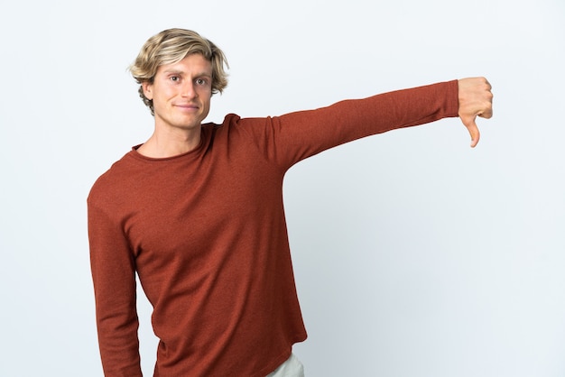 Photo english man over white showing thumb down with negative expression