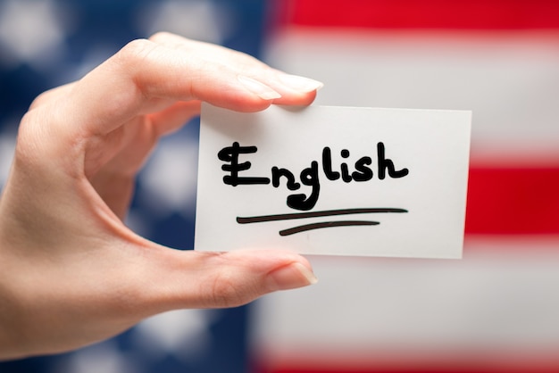 English text on a card. American flag background.