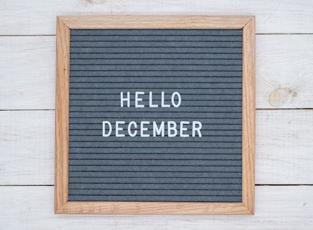 Photo english text hello december on a letter board in white letters