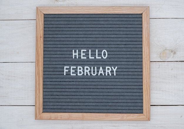 English text Hello February on a letter Board in white letters