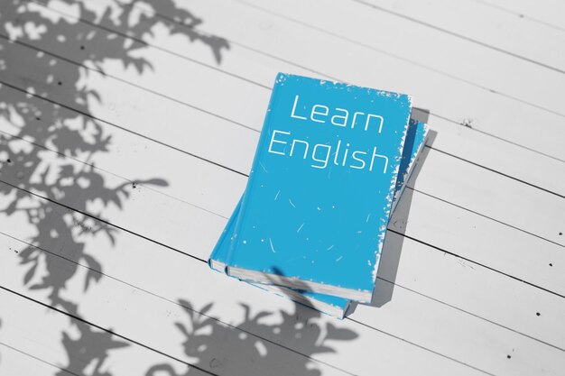 english textbook on a white wooden table english language learning english grammar learn english book for language learning 3d rendering