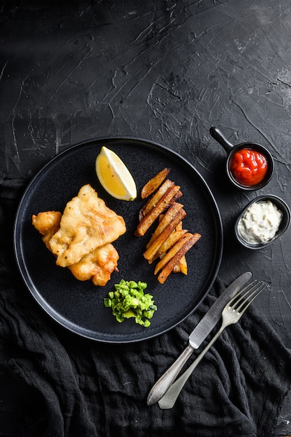 English Traditional Fish and chips with mashed minty peas and tartar sauce