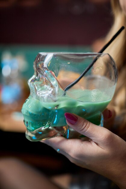 enjoy a colorful cocktail presented in a unique and eye catching skull glass style