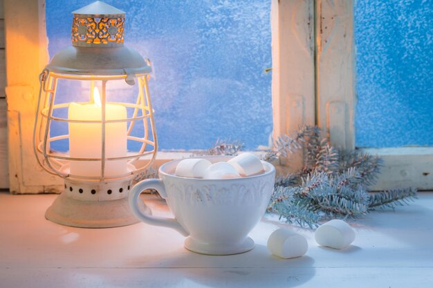 Enjoy your hot Christmas chocolate with marshmallows and candle