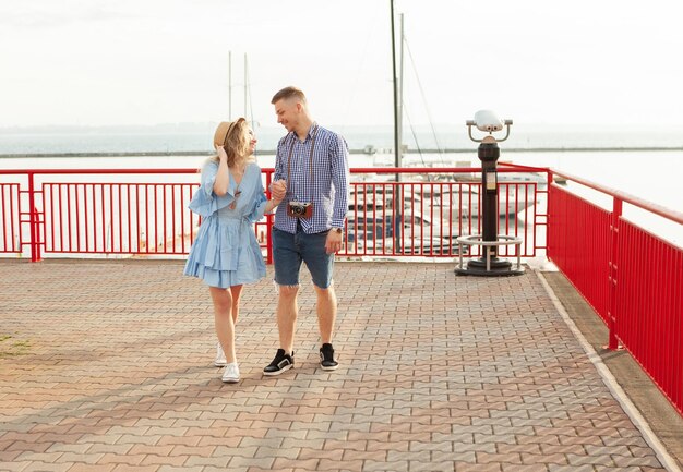 Enjoying every moment together. Young couple in love tourist Spend time walking together in the seaport. Romantic, love, travel concept